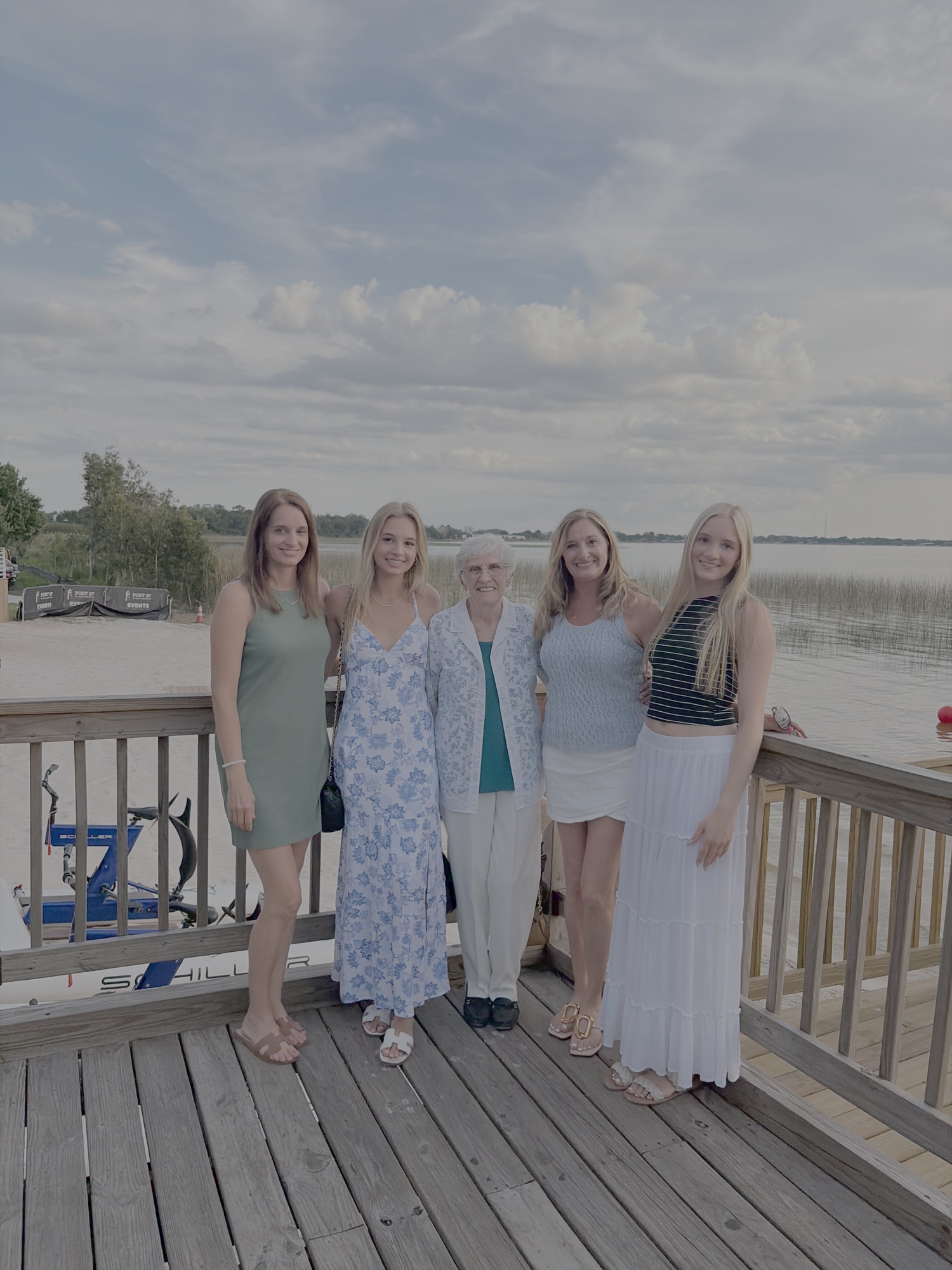 Five women from several generations together by the water
